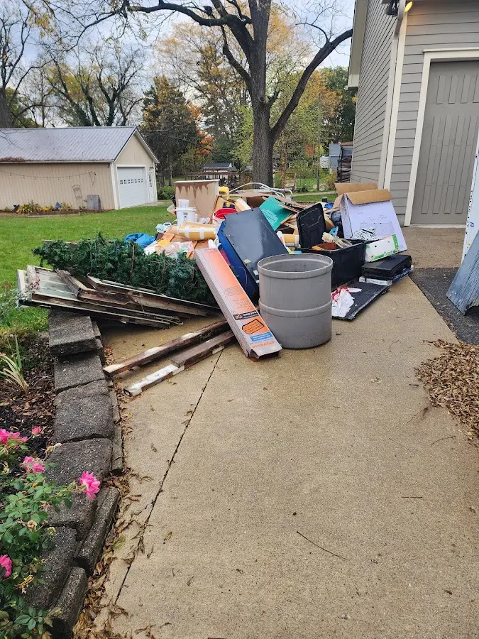 Dumpster being loaded with debris for Residential Dumpster Rental in Ennis